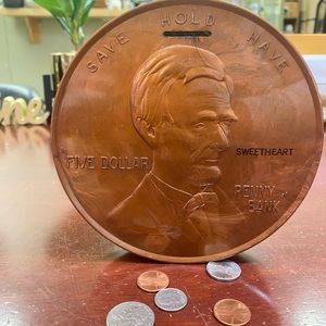 Vintage 1960 five dollar penny shaped bank